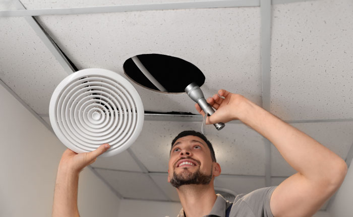 A man installing a ceiling fan, representing things partners never tell each other.