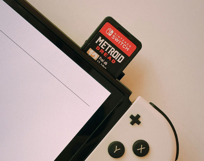 A Nintendo Switch with a Metroid Dread game cartridge inserted, showcasing things partners tell each other.