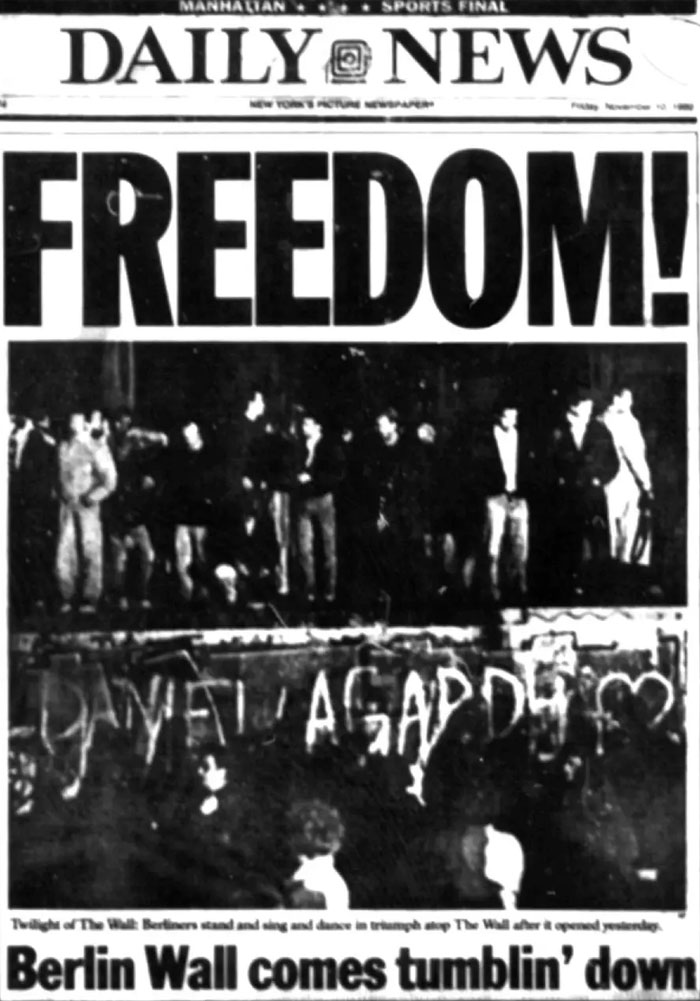 Historical newspaper headlines: Daily News reports Freedom! Berlin Wall comes tumblin' down, showing people on the wall.