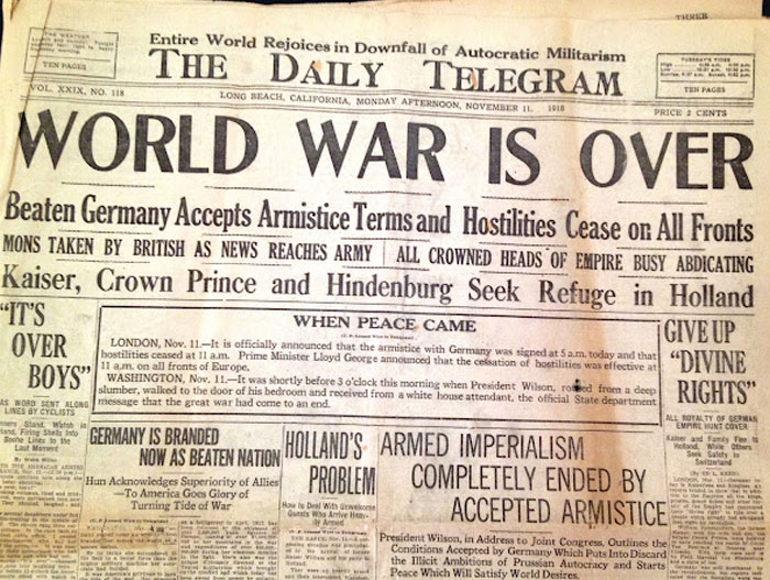 Historical newspaper headline: World War Is Over, marking the end of the conflict. A significant front page headline.