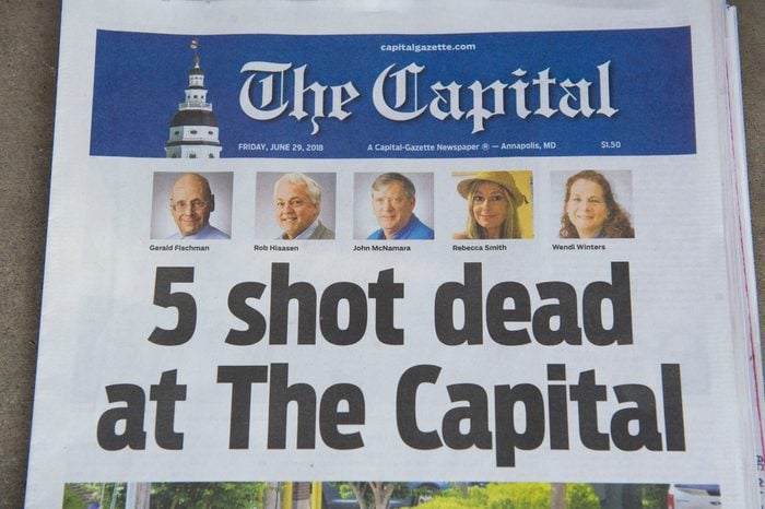 Historical newspaper headline from The Capital with 5 shot d**d and the photos of the victims, relating to Men Walk On Moon.