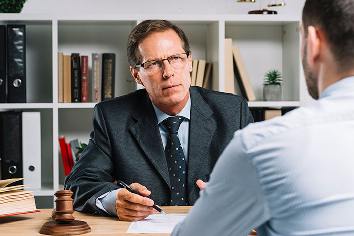Lawyer consulting man about HOA water access dispute scam case documents Lawyer consulting man about HOA water access dispute scam case documents