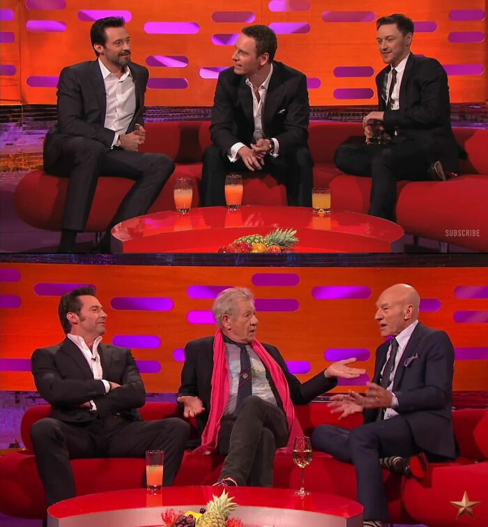 Actors chatting on a TV talk show set with red couches and drinks
