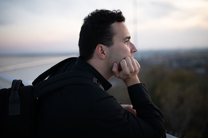 A thoughtful man, looking into the distance, pondering his open marriage decision and avoiding divorce. A thoughtful man, looking into the distance, pondering his open marriage decision and avoiding divorce.