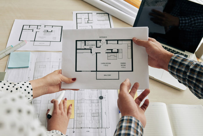 A couple reviews blueprints for their new house, preparing to start life together, potentially causing a mom's breakdown.