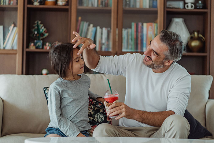 A man with a beard and a young girl sitting on a sofa, as the wife is at her wits end after years of marriage. A man with a beard and a young girl sitting on a sofa, as the wife is at her wits end after years of marriage.