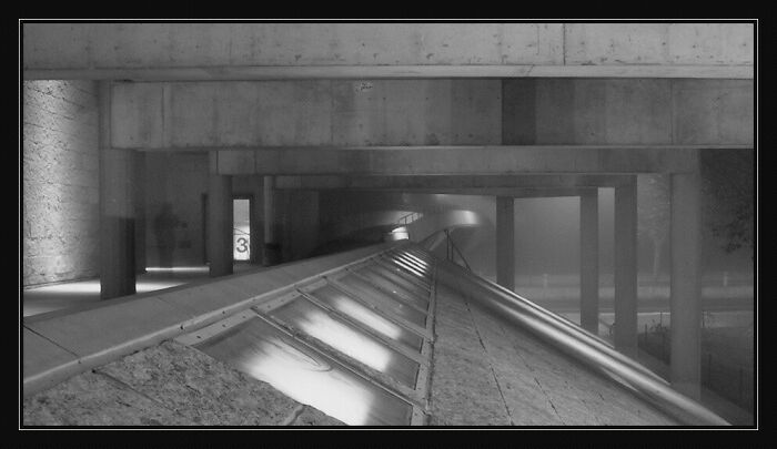 Dark, foggy urban scene with spooky concrete structure