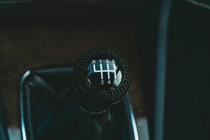 Close-up of a car manual gear shift k**b with six speeds
