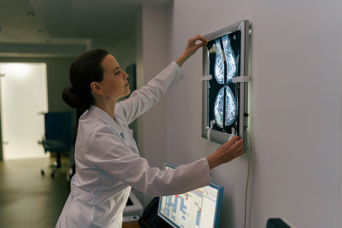 A doctor examining medical symptoms on an x-ray, showing what doctors wish more people would stop ignoring.