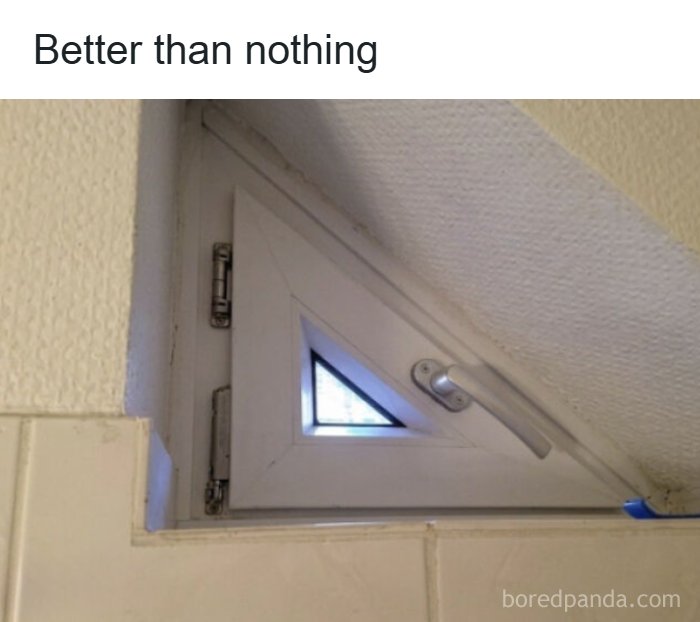 A tiny, triangular window squeezed into a tight space, showcasing an architecture and design fail.
