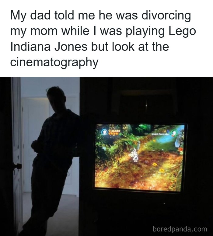 Silhouette of dad standing by door while child plays Lego Indiana Jones video game