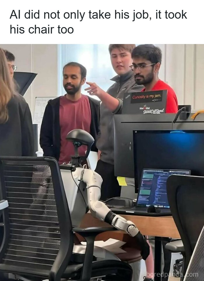 A funny meme showing a robot sitting at a desk, taking a man's job, illustrating hilarious memes.