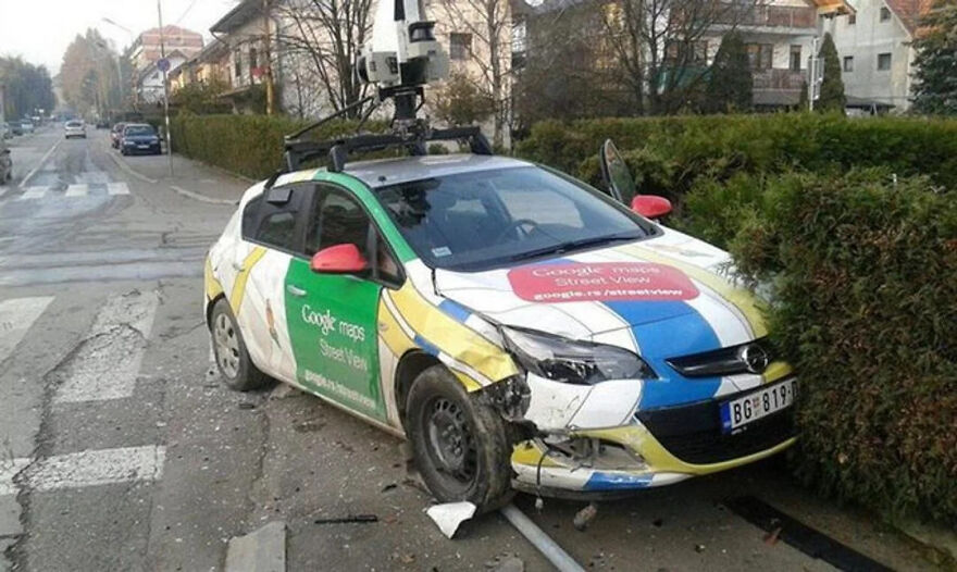 A bizarre Google Street View photo of a Google Street View car involved in an accident, with front-end damage.