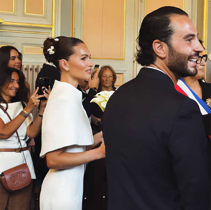 Thylane Blondeau wedding with her French DJ husband, smiling and walking past guests.