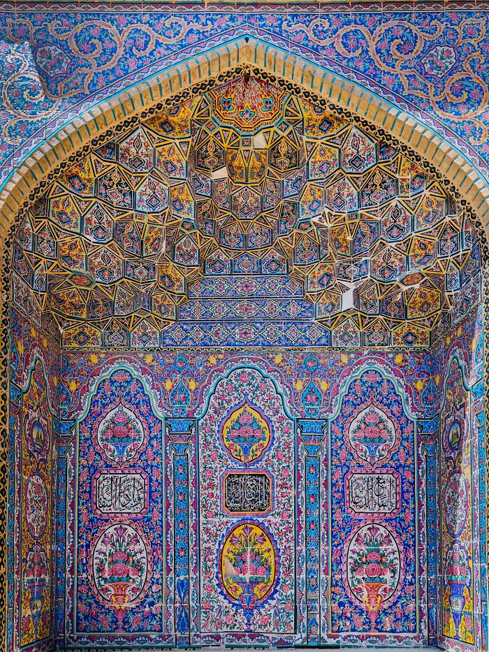 Intricate Persian geometric and floral tile patterns in mosque arch decoration