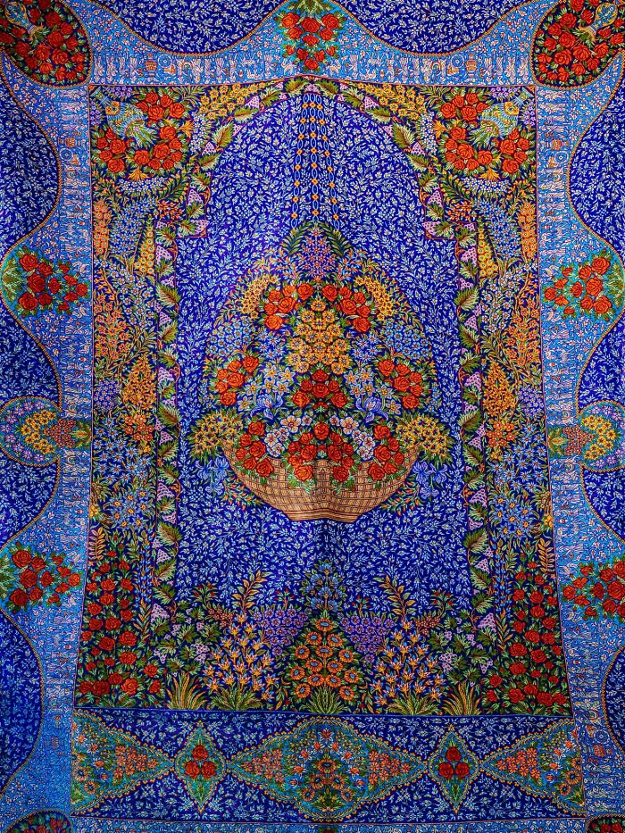Classic Persian floral pattern design with vibrant blue and red colors on textile art
