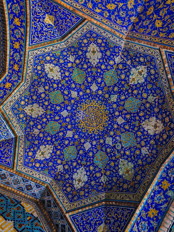Detailed blue and gold Persian ceiling mosaic showcasing complex geometric patterns