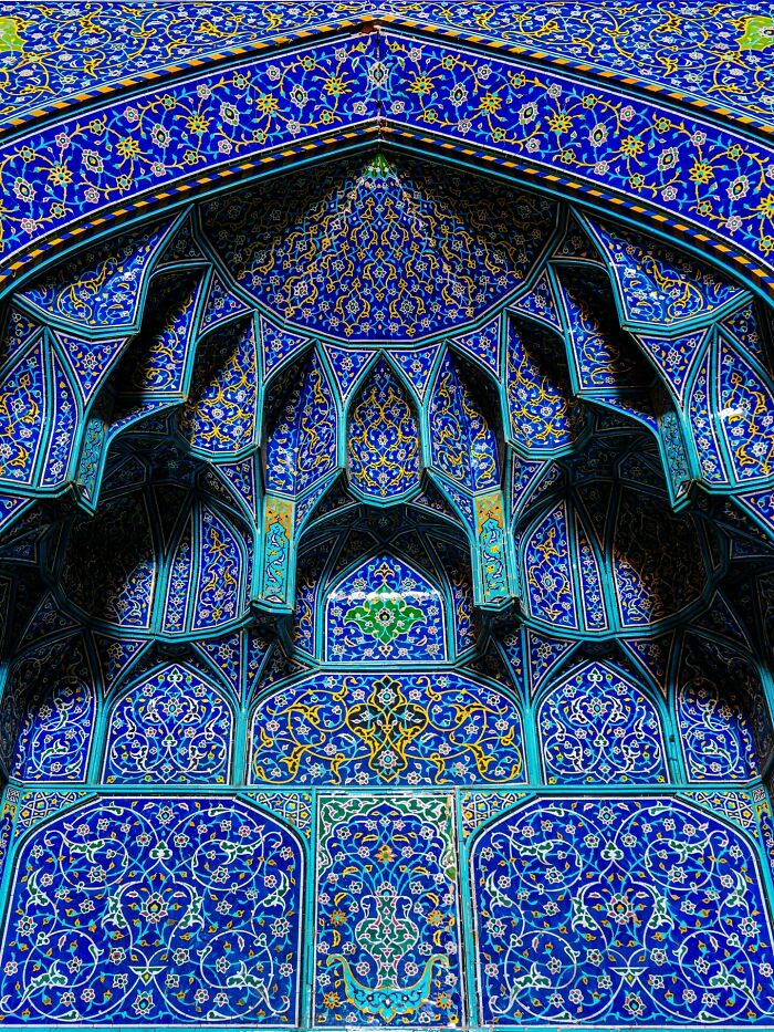 Ornate Persian tilework with complex geometric patterns and vibrant blue hues