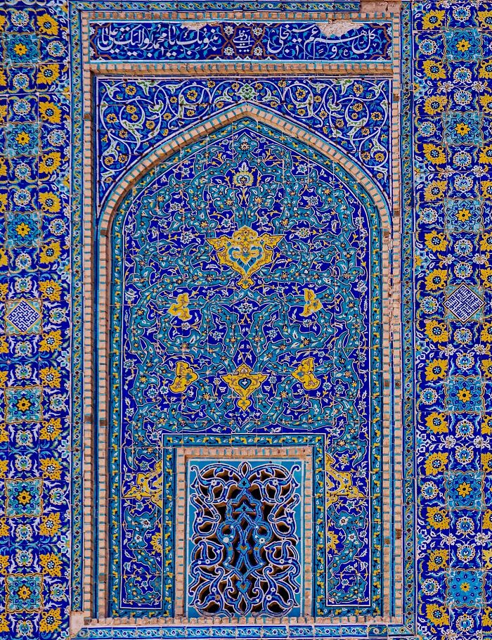 Persian tilework arch with blue and yellow floral geometric patterns