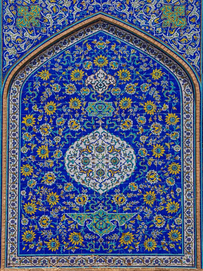 Blue and yellow Persian tilework with intricate floral patterns and geometric shapes