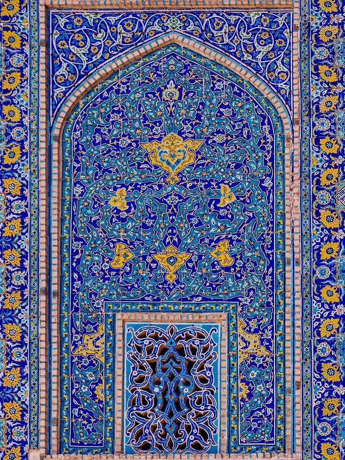 Detailed Persian tile mosaic with blue background and complex floral geometry