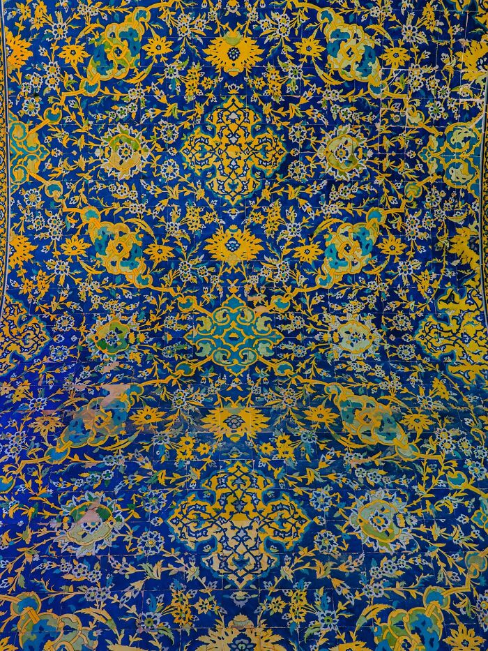 Yellow and blue Persian tile pattern with floral and vine elements