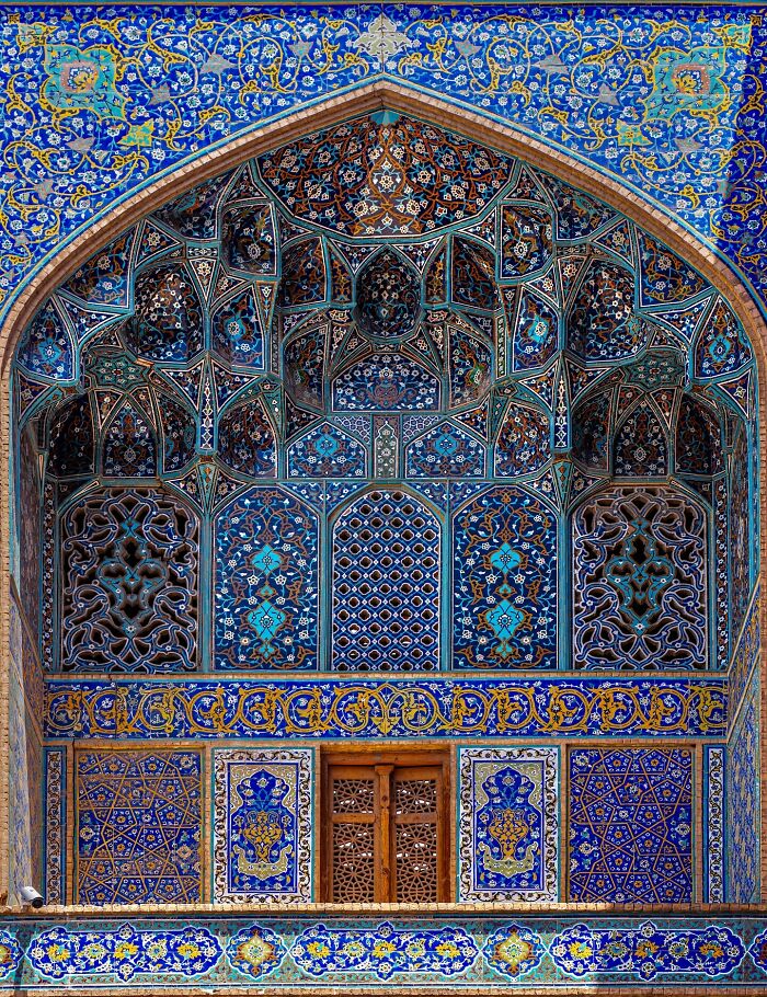 Persian architectural facade adorned with blue and gold geometric tilework