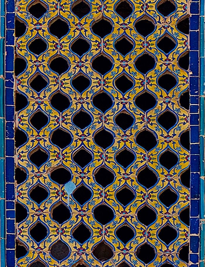Intricate Persian geometric patterns with yellow and blue tilework design
