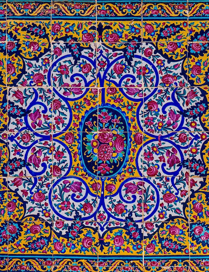 Close-up of classical Persian tile floral motifs with bold colors and detailed geometric patterns