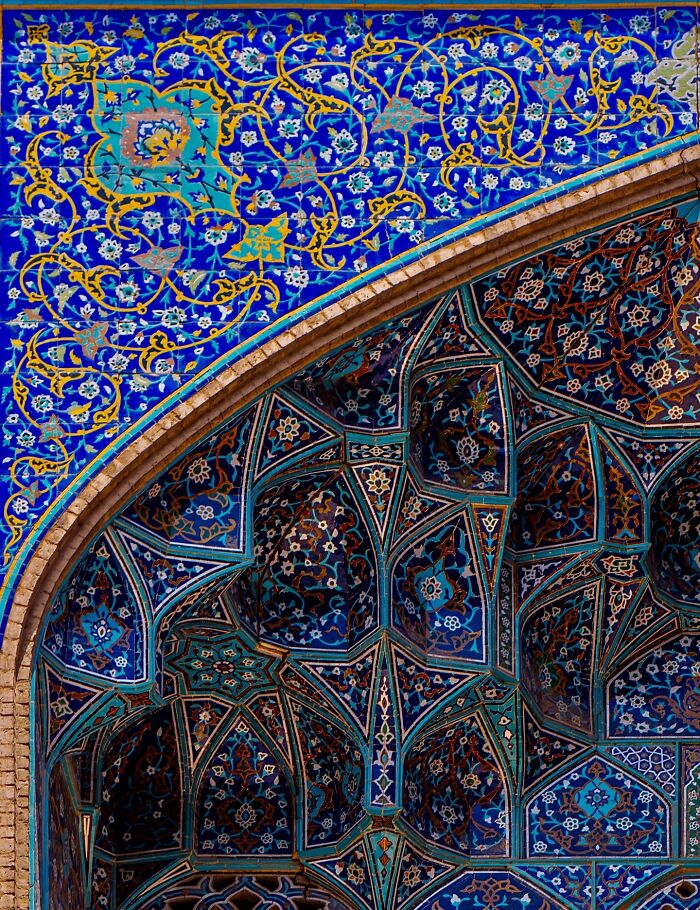 Close-up of blue Persian tilework featuring floral and geometric designs
