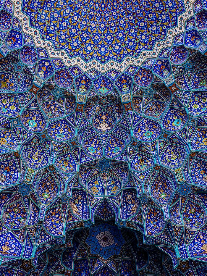 Complex blue Persian mosaic patterns decorating a mosque ceiling