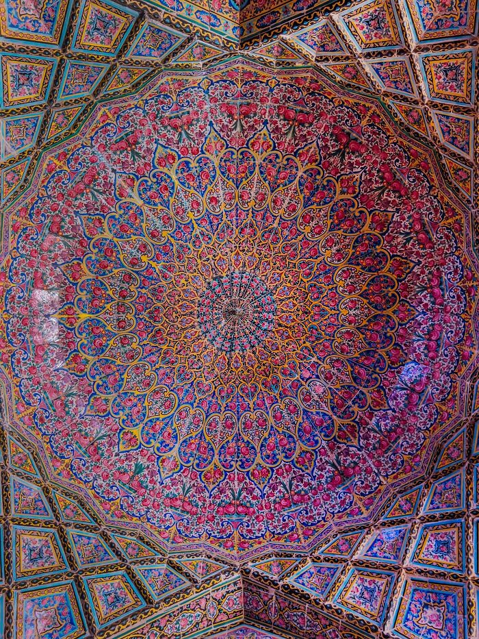 Ornate Persian dome ceiling with symmetrical floral and geometric pattern tiles