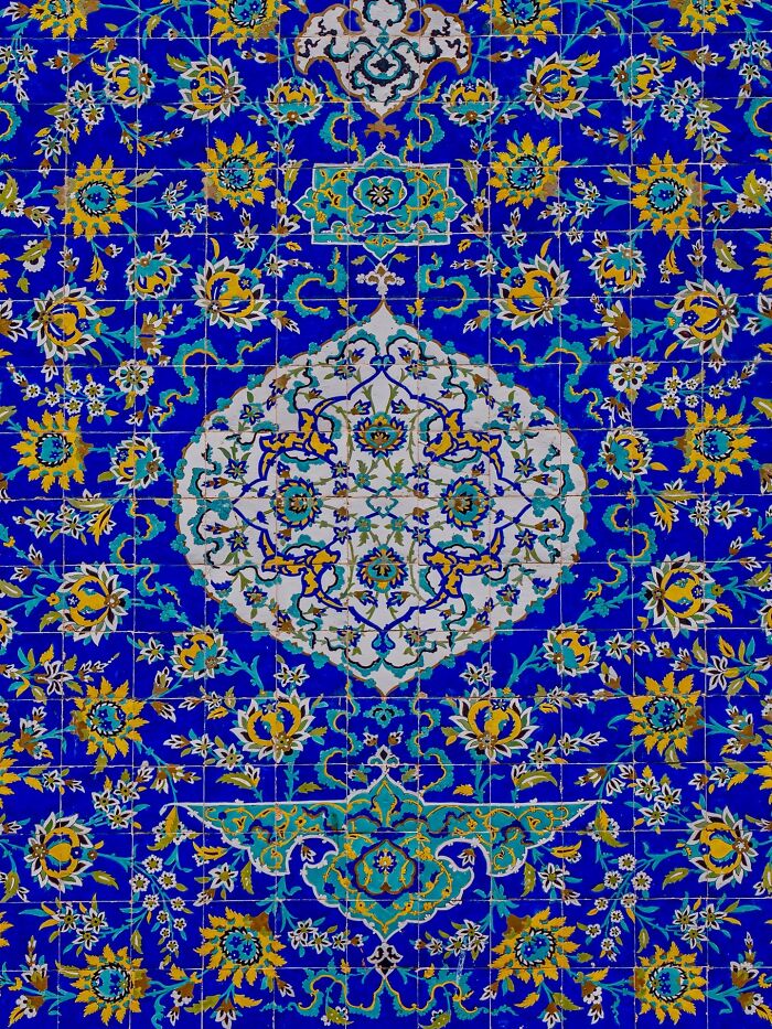 Persian floral and geometric tilework in rich blue and yellow colors