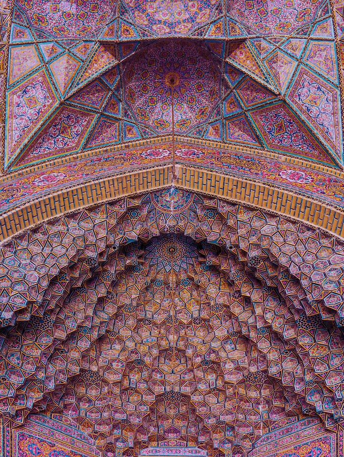Detailed Persian geometric patterns on a mosque ceiling with vibrant hues