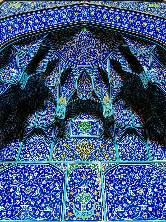 Classic Persian blue tile mosque facade with geometric floral designs