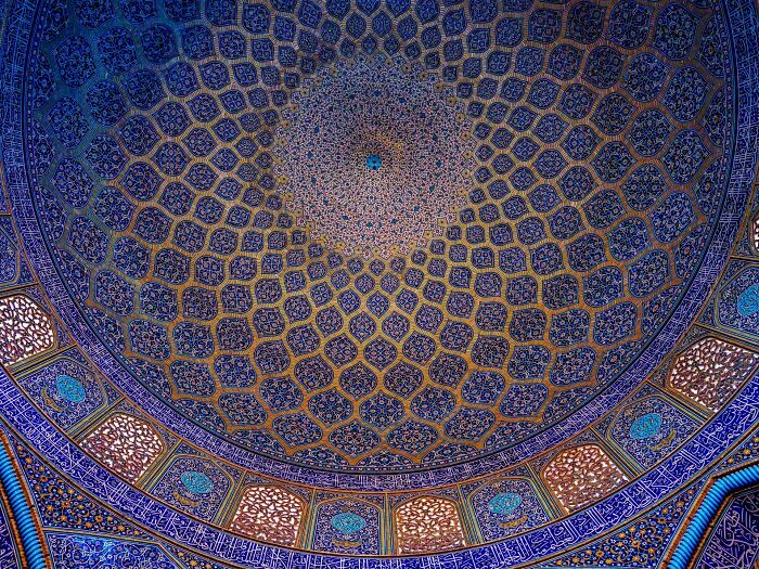 Detailed Persian geometric and floral tilework on mosque dome interior