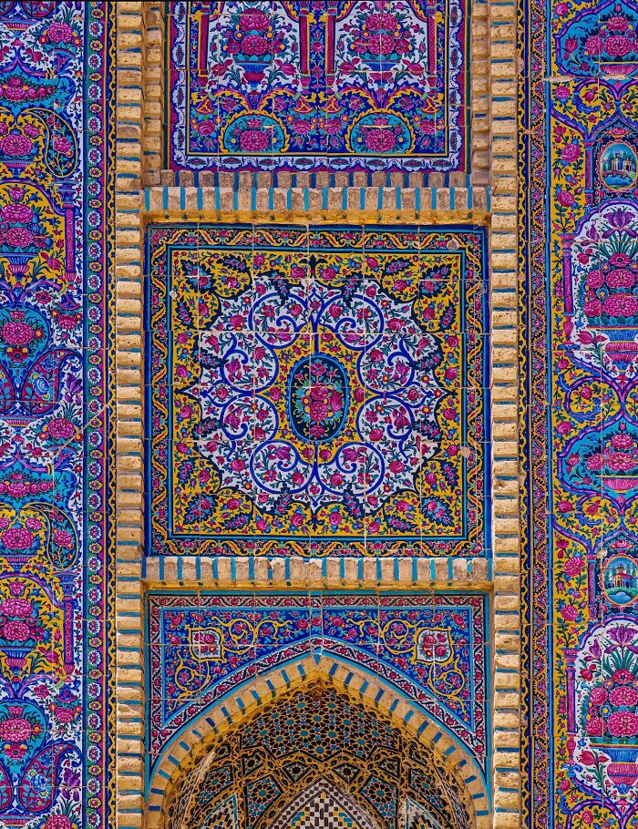 Colorful Persian mosaic tile with floral and geometric motifs on building facade