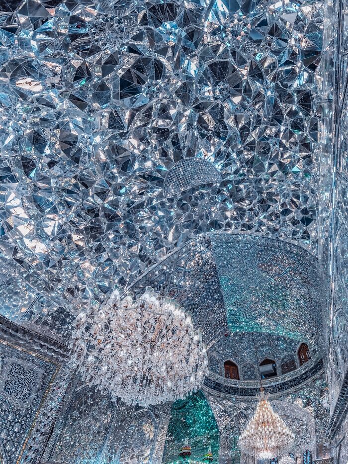 Reflective mirrored mosaic ceiling and chandelier showcasing Persian geometry