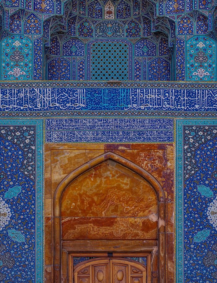 Persian mosque entrance with Arabic calligraphy and detailed blue tile geometry