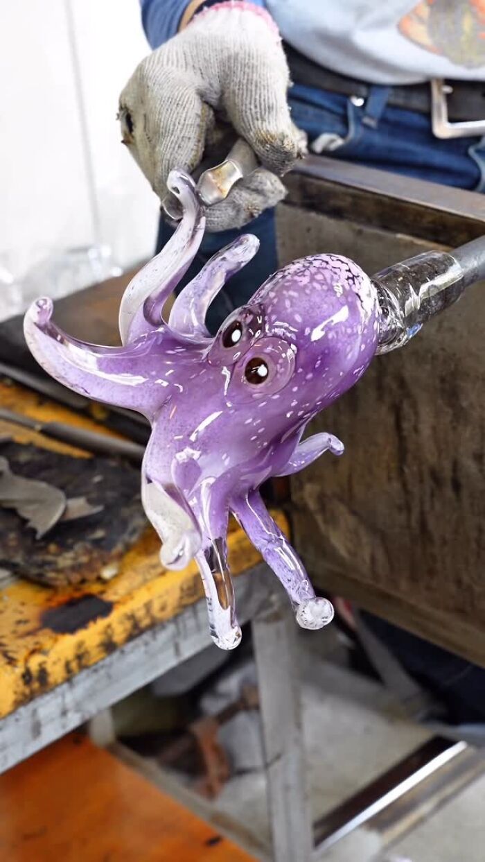 Japanese artist creates hyper-realistic glass food, working on a purple glass octopus.