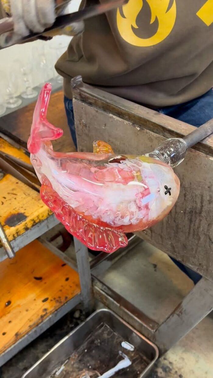 Japanese artist creates hyper-realistic glass food, shaping a pink glass fish during the process.