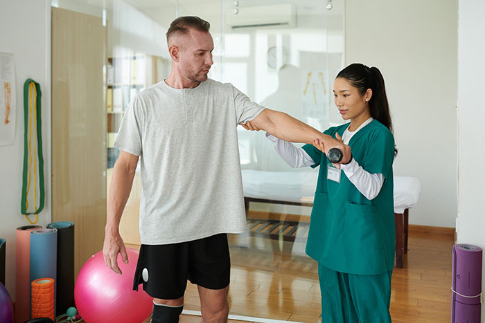 A man receiving physical therapy, showing industry secrets within the healthcare field.