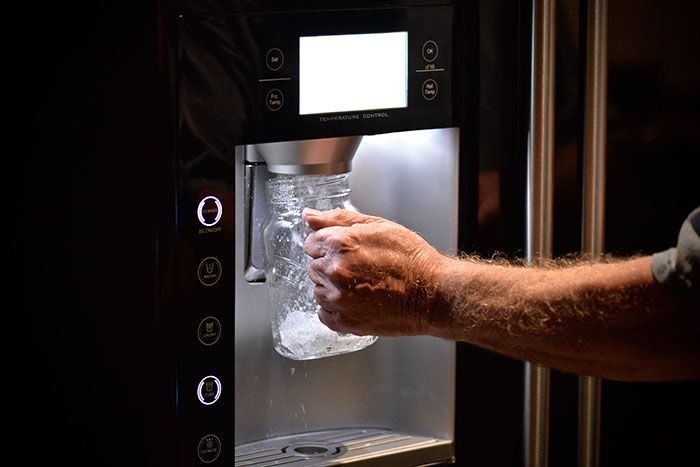 A person fills a glass jar with ice from a refrigerator dispenser. Industry secrets customers were never meant to hear.