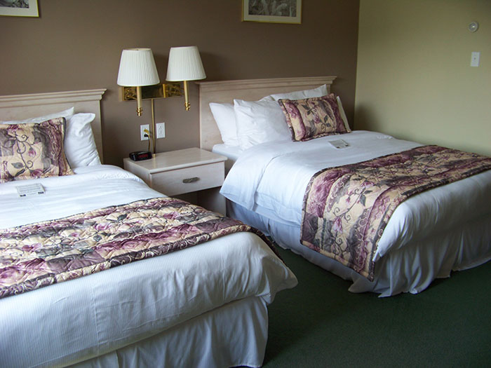Hotel room with two beds and nightstand, an industry secret customers were never meant to hear.