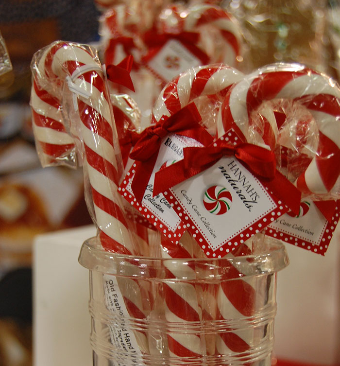 A clear container holds individually wrapped candy canes with red bows, revealing industry secrets customers were never meant to hear.