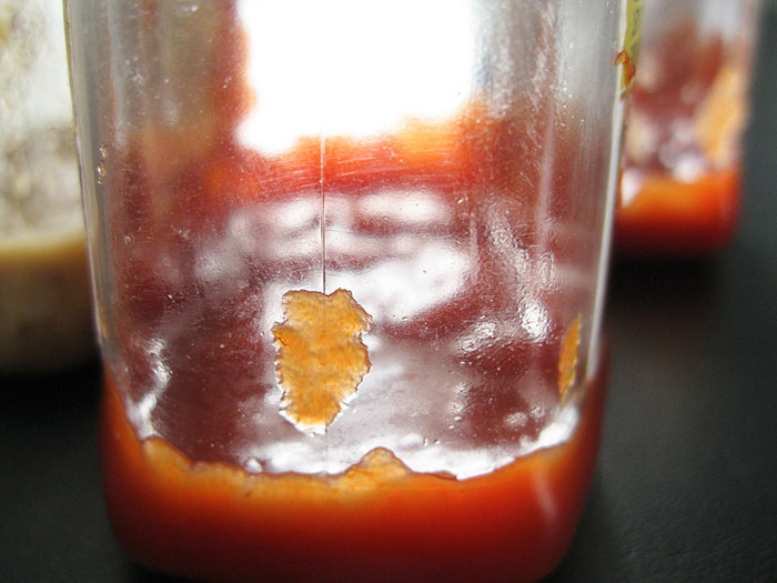 A dirty, cracked glass bottle, symbolizing industry secrets that might make fewer people fly.