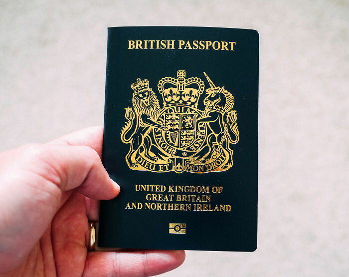 Hand holding a British Passport; influencer arrested in Dubai on grave charges.