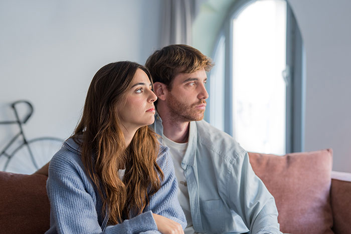 An introverted GF and her boyfriend looking contemplative on a couch after a disappointing birthday bar crawl. An introverted GF and her boyfriend looking contemplative on a couch after a disappointing birthday bar crawl.