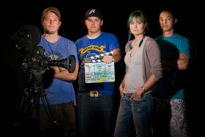 Group of filmmakers standing with camera and clapperboard unsettling thing found about friend