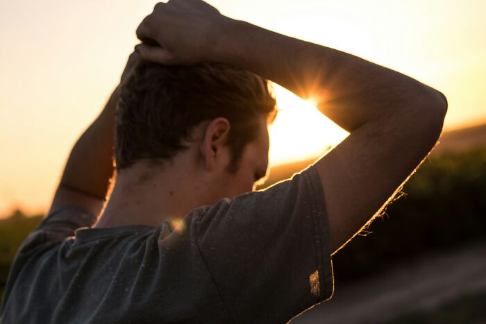 Man looking stressed outside during sunset after walkouts